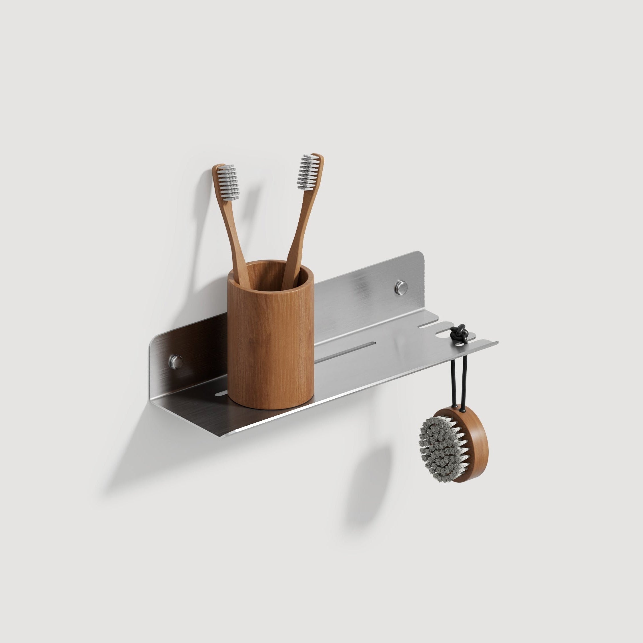 Wall-mounted chrome steel shelf with  hook and a brown cup holding toothbrushes on a white background