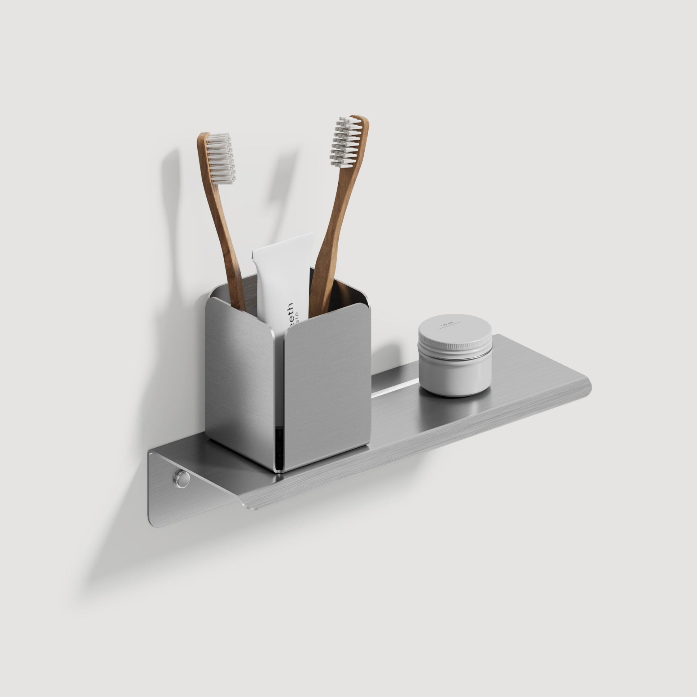 Brushed steel small shower shelf wirh toothbrush holder and two toothbrushes  on a white background